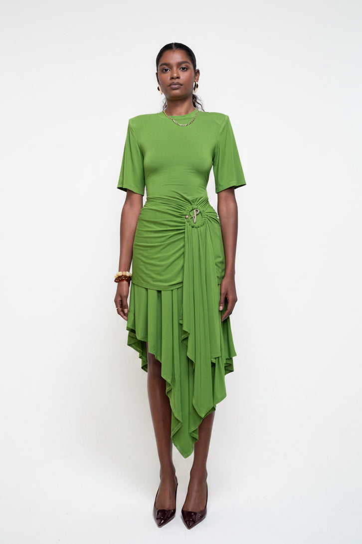 Woman wearing a green dress against a white background