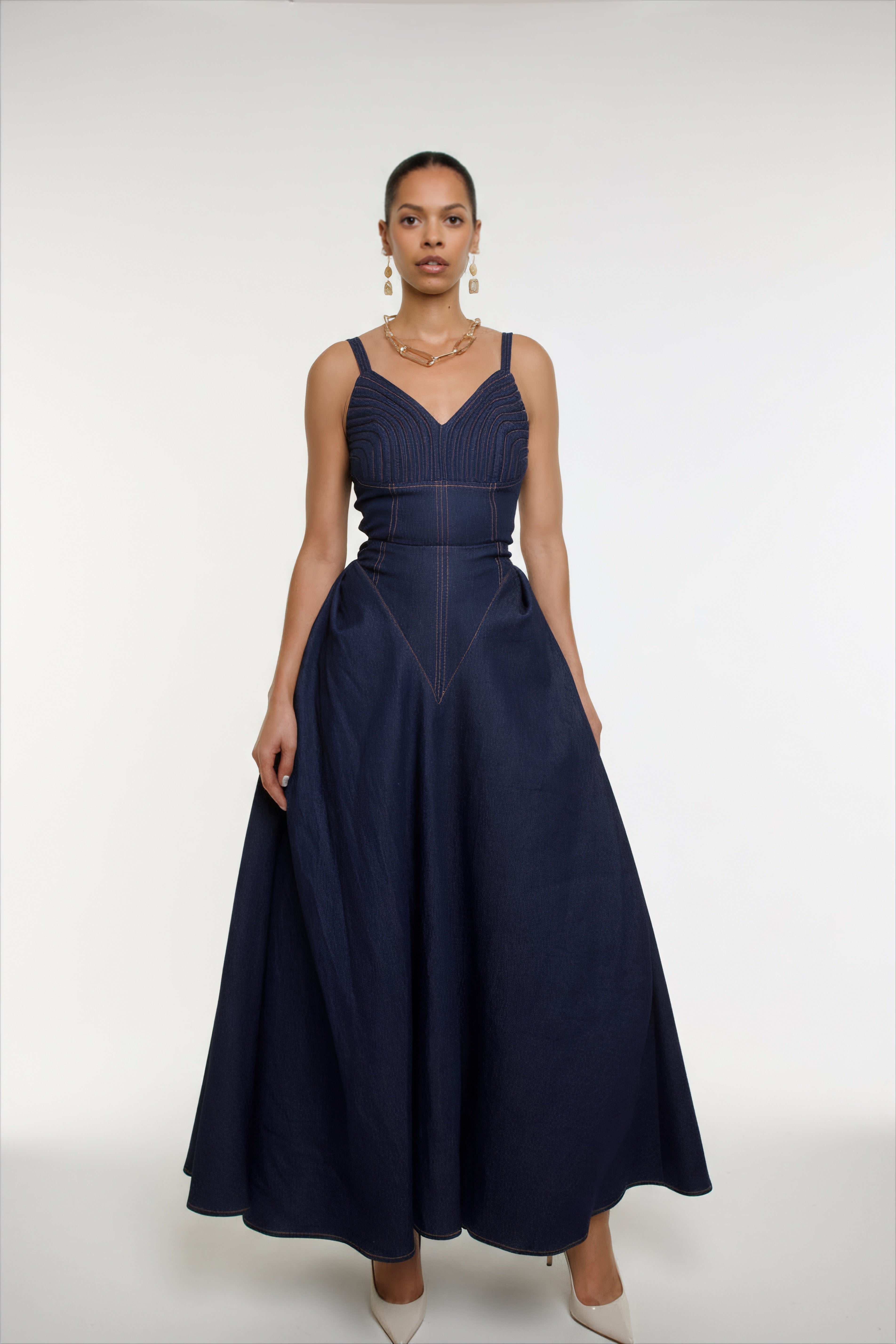 Woman wearing a navy blue dress with a white background