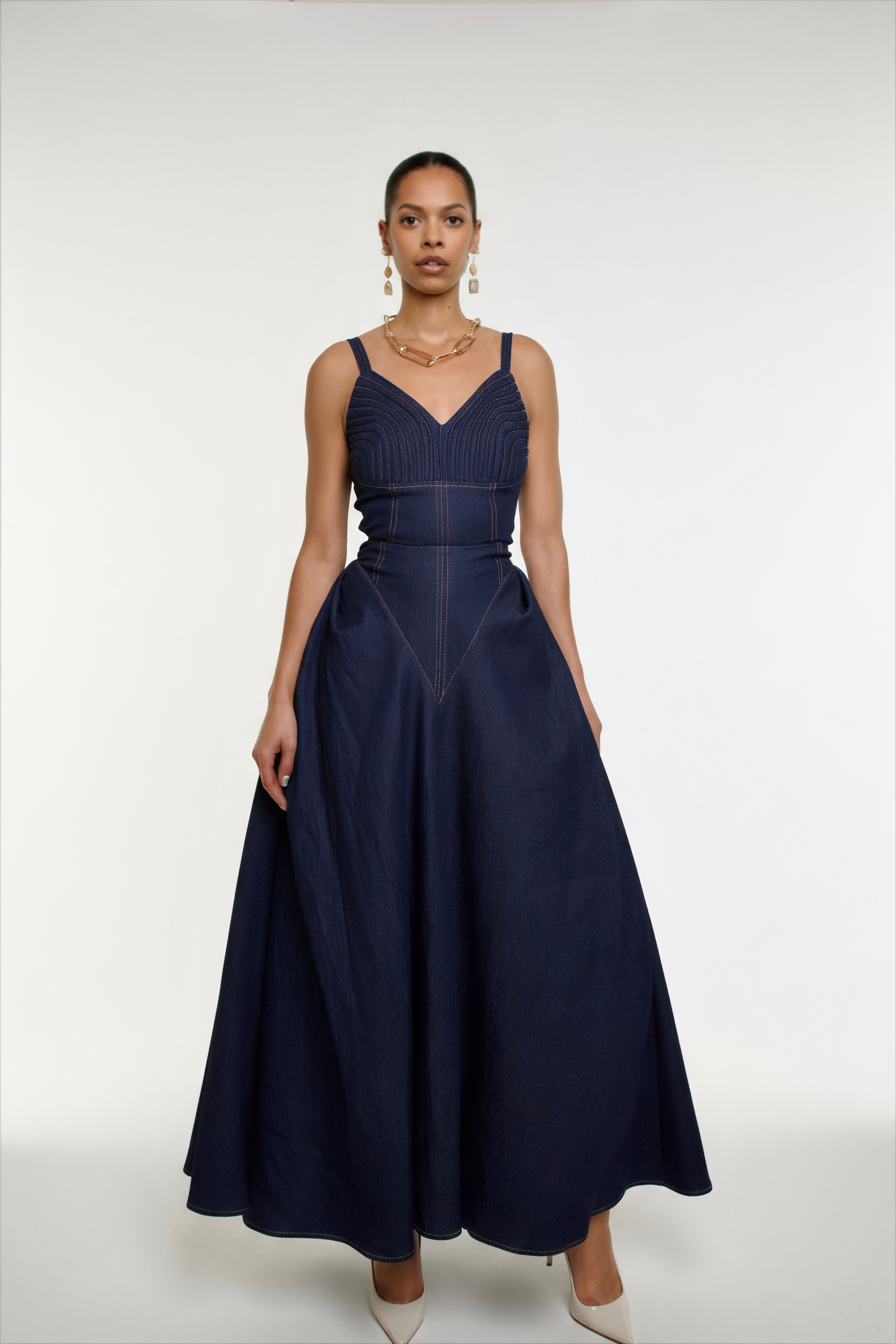 Woman wearing a navy blue dress on a white background
